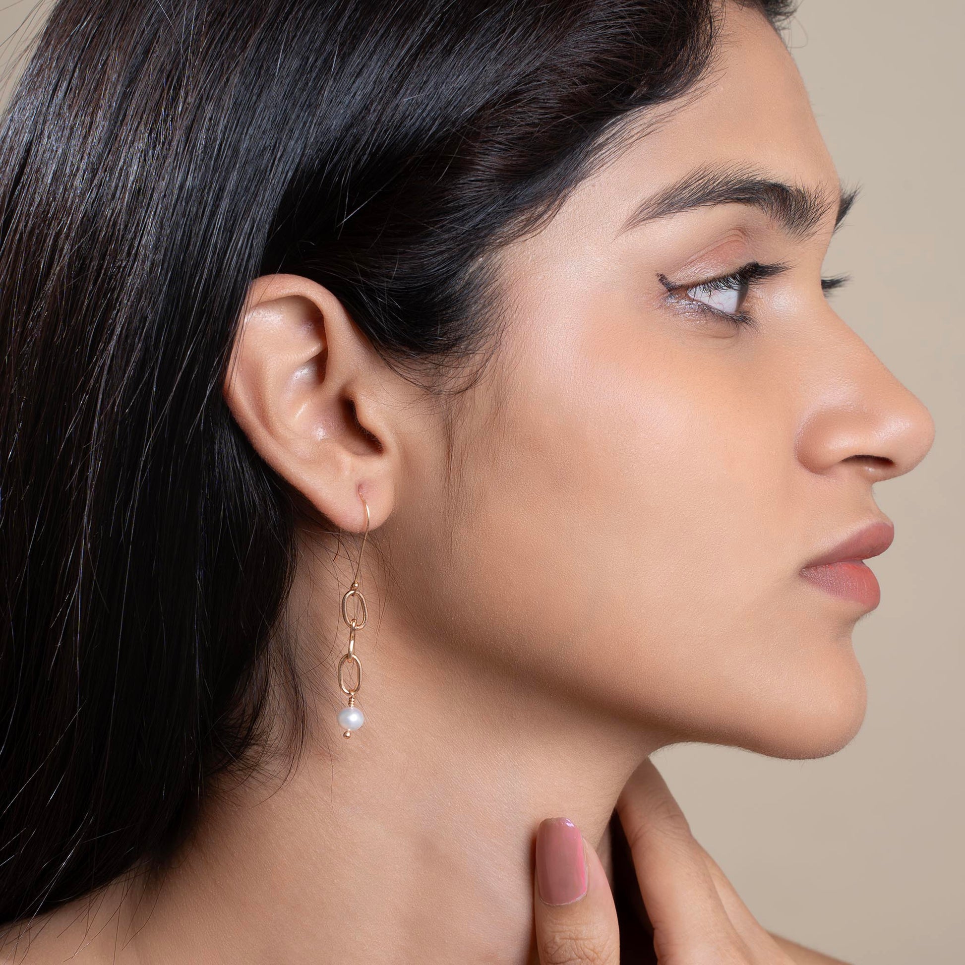 OVAL LINK PEARL DROP EARRING LEFT VIEW ON MODEL