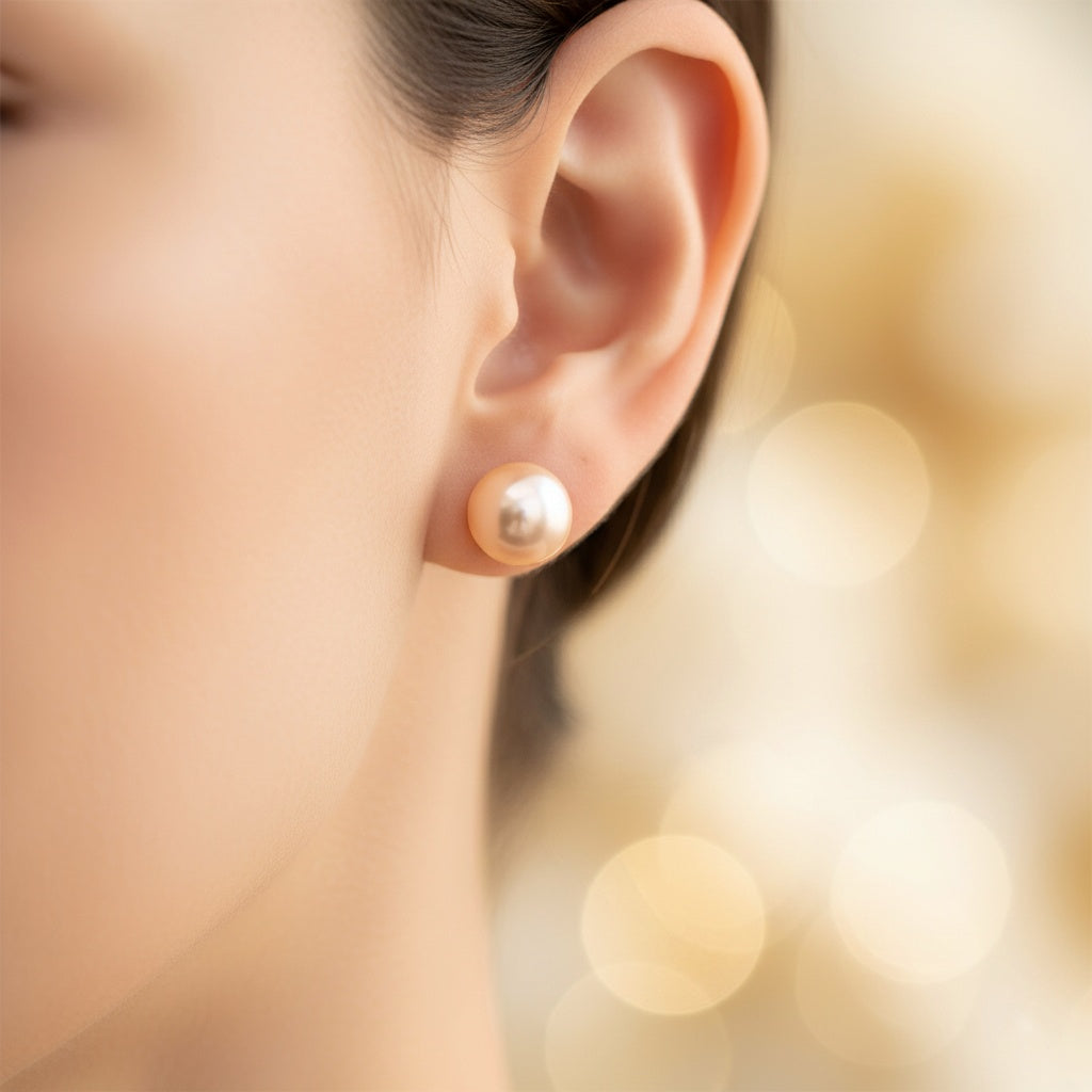 Close-up of an ear wearing a pearl earring with a blurred background